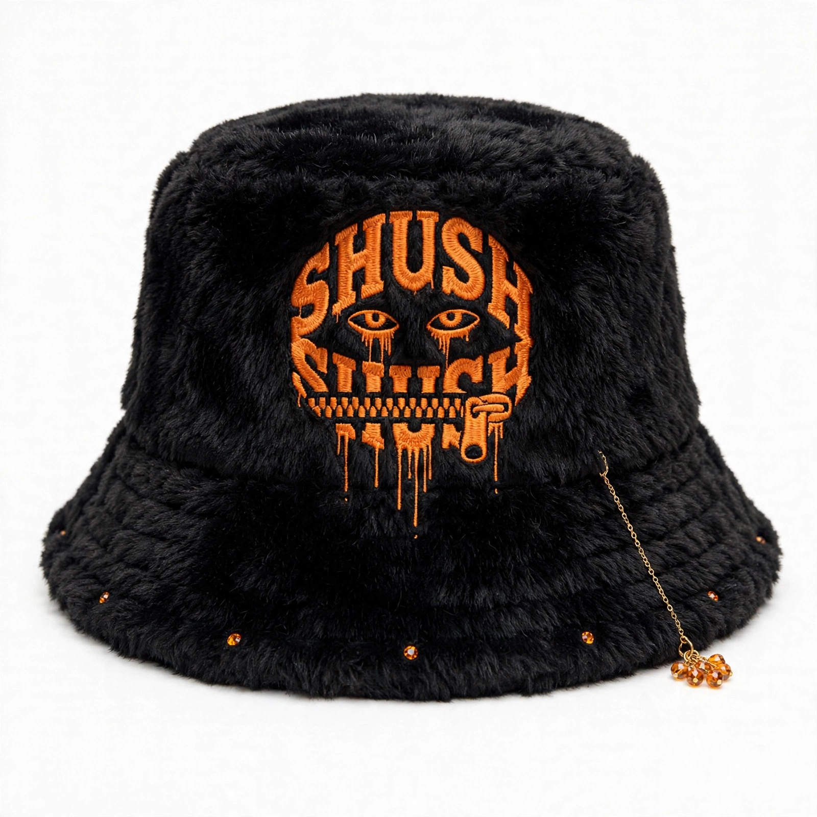 Black faux-fur SHUSH bucket hat with an orange dripping logo, amber gem dangle and small gems along the front brim