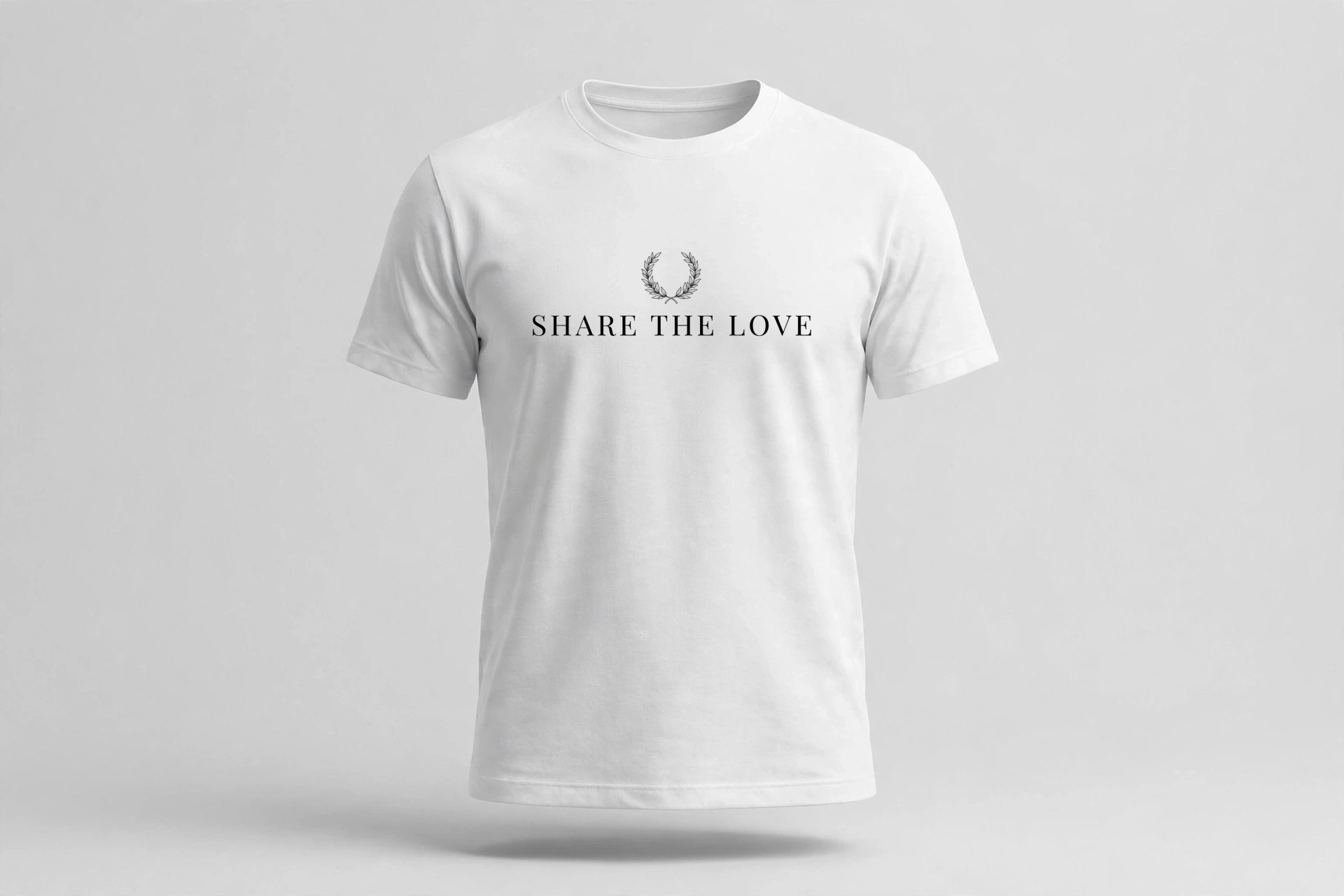 White T-shirt laid flat with a small black laurel wreath and Share The Love print at the left chest